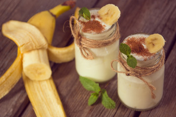 Organic homemade sweet milk dessert with banana, cinnamon and mi