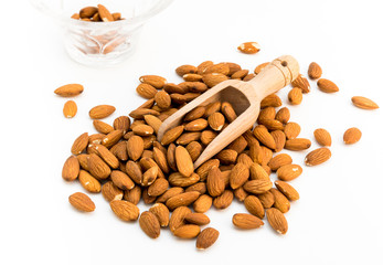 Almond nuts on wooden spoon isolated on white background. 