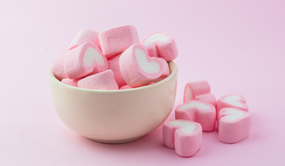 Pink heart-shaped marshmallow in with pink background