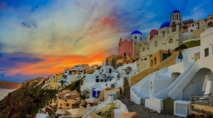 Amazing panorama sunset view with white houses in Oia village on