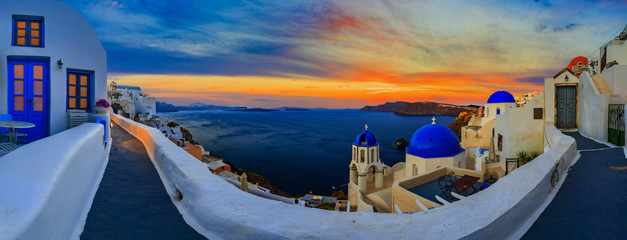 Amazing panorama sunset view with white houses in Oia village on