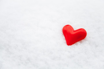Fototapeta premium Ceramic red heart on the fresh snow