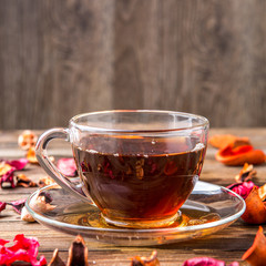 Glass teacup on table petals