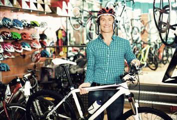 Fototapeta na wymiar man choosing sport bike and helmet in store.