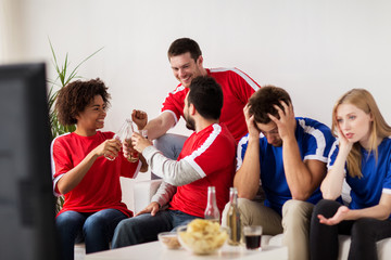 friends or football fans watching soccer at home