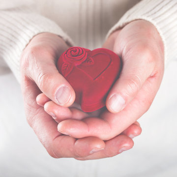 Heart,Gift in the Hands of Men. Offer Love To A Woman.Holiday Valentine's Day.Wedding.toned image..selective focus.
