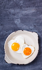 Fried egg in heart shape on the pan.Holiday Valentine's Day.Breakfast. Healthy Food.selective focus.