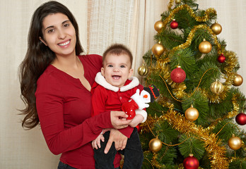 happy family portrait in christmas decoration, winter holiday concept, decorated fir tree and gifts