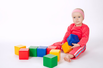 little girl playing with cubes