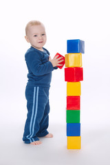 boy plays with cubes on white