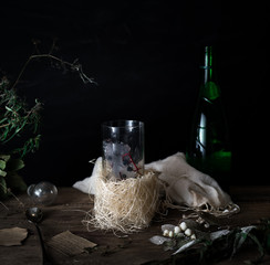 still life, vintage. a glass of mineral water and berries, bouquet on  wooden table. dark backgrounds. .