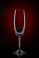 Empty wine glass on dark red