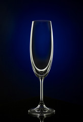 Empty wine glass on dark red