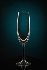 Empty wine glass on dark red