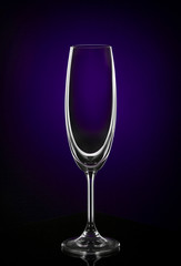 Empty wine glass on dark red