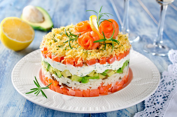 Layered salad with salmon, avocado and cream cheese