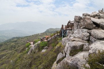 View of stairs and lush and rocky landscape at the Geumjeongsan Mountain in Busan, South Korea.
