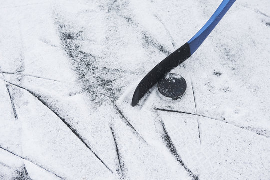 Hockey stick and puck on ice
