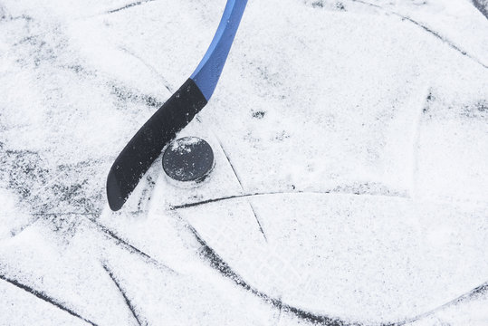 Hockey stick and puck on ice
