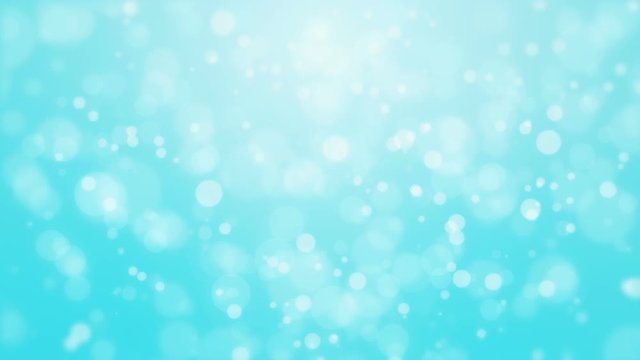 Festive turquoise blue bokeh background with flickering light particles imitating underwater bubbles.