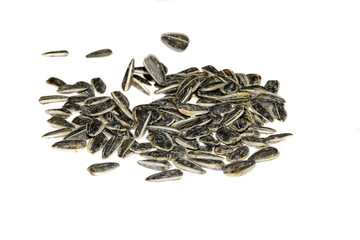 Closeup of black baked sunflower seeds isolated on white background