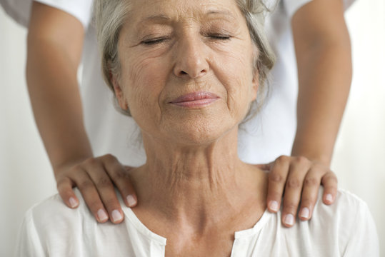 Senior woman getting a shoulder massage