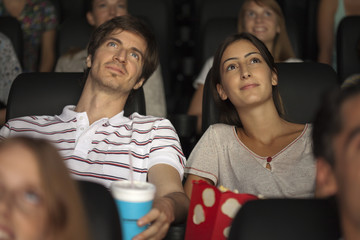 Couple enjoying movie in theater