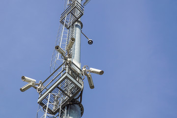 Fototapeta na wymiar security camera on pole high tower of CCTV system in daytime