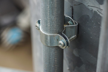 metal tube water pipes pipe clamps on metallic background construction concept.