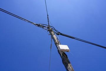 Wooden power pole with blue sky