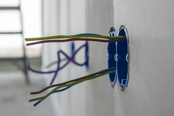 Electrical wires sticking out of a wall