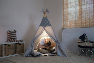 father frustrated and in despair sitting in the playroom © familylifestyle