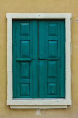  vintage closed wooden window on grunge wall background