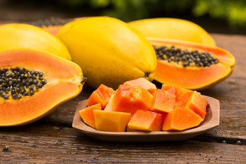 Sliced fresh papaya on wooden background