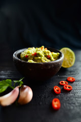 Bowl of guacamole with fresh ingredients