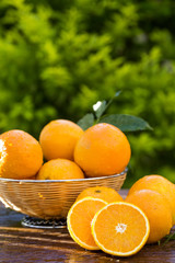 Sweet fresh oranges in natural light on old wood