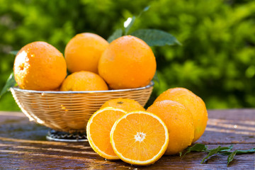 Sweet fresh oranges in natural light on old wood