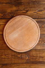 Fototapeta na wymiar Wooden round board for pizza