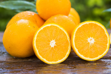 Sweet fresh oranges in natural light on old wood