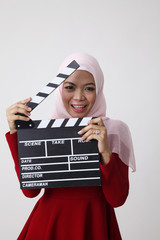 malay woman holding clapper board