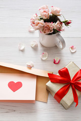 Valentine day background, heart and flowers on white wood