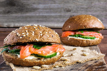 two sandwiches with cereals bread and smoked salmon with herbs