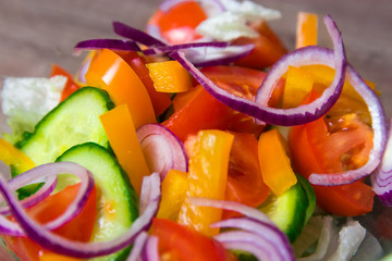 Fresh Salad in a Glass Bowl with Onions, Bell Pepper and Tomatos