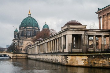 Fototapeta na wymiar BERLIN, GERMANY - DECEMBER 22, 2016: Berlin Cathedral (Berliner Dom) and Museum Island (Museumsinsel) reflected in Spree River, Berlin, Germany. Vintage style