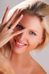 nude blonde girl with golden ring emerald and diamond