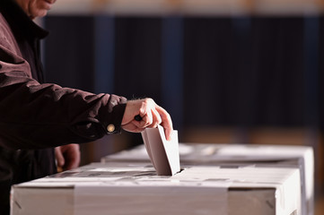 Person casting vote into ballot box - 132715276