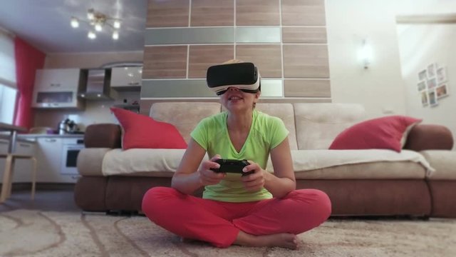 Beautiful woman with virtual reality helmet are playing computer console game front view