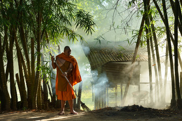 Fototapeta premium Buddhist monks in mist sunrise,Thailand