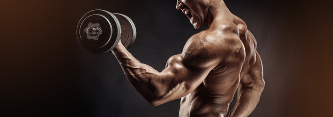 Muscular bodybuilder guy doing exercises with dumbbell - 132717693
