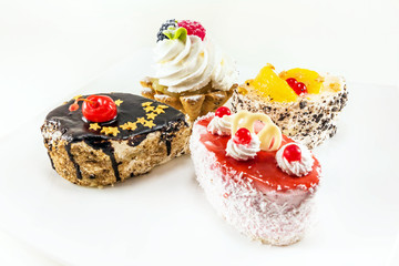 four mini cake with cream and berries